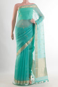 Sea Green Organza Saree with Zari Butta on the body and Zari Border.  displayed on a mannequin