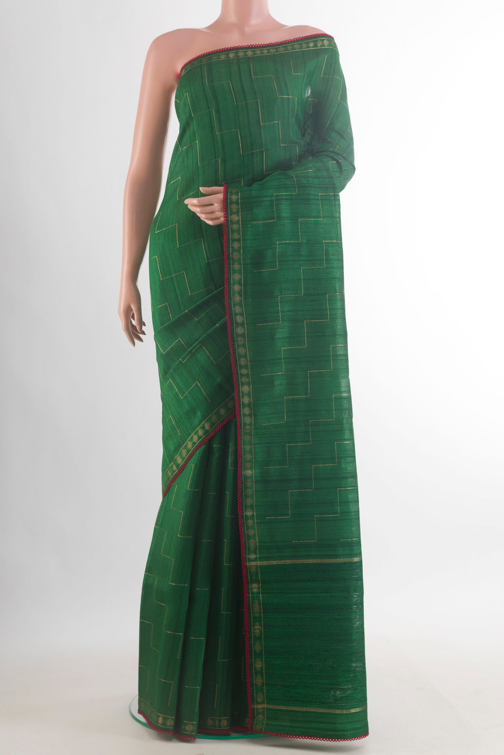 Green Tussar Saree with Zig Zag design on the body and Zari Border.  displayed on a mannequin
