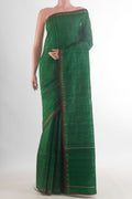 Green Tussar Saree with Zig Zag design on the body and Zari Border.  displayed on a mannequin