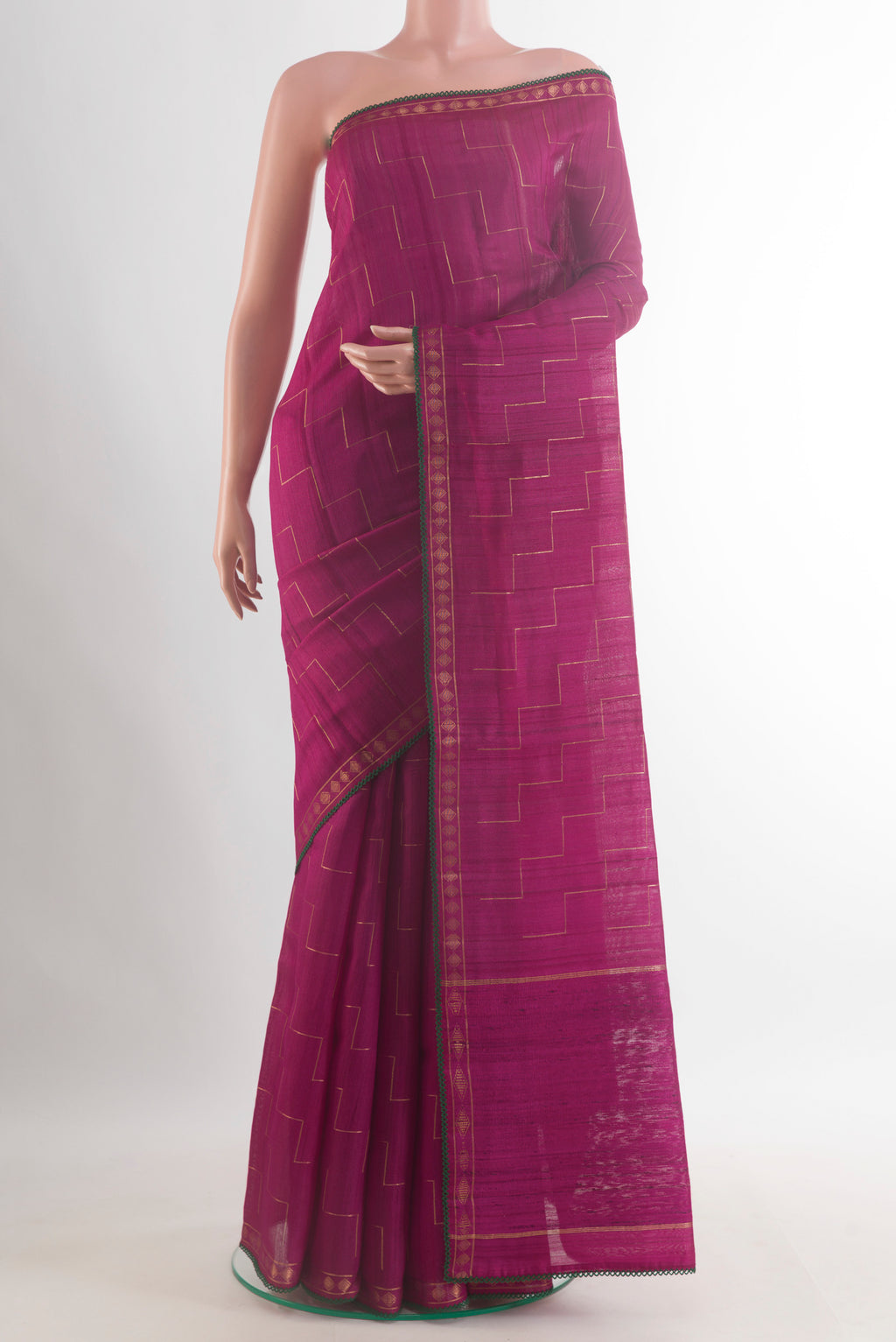 Magenta Tussar Saree with Zig Zag design on the body and Zari Border.  displayed on a mannequin