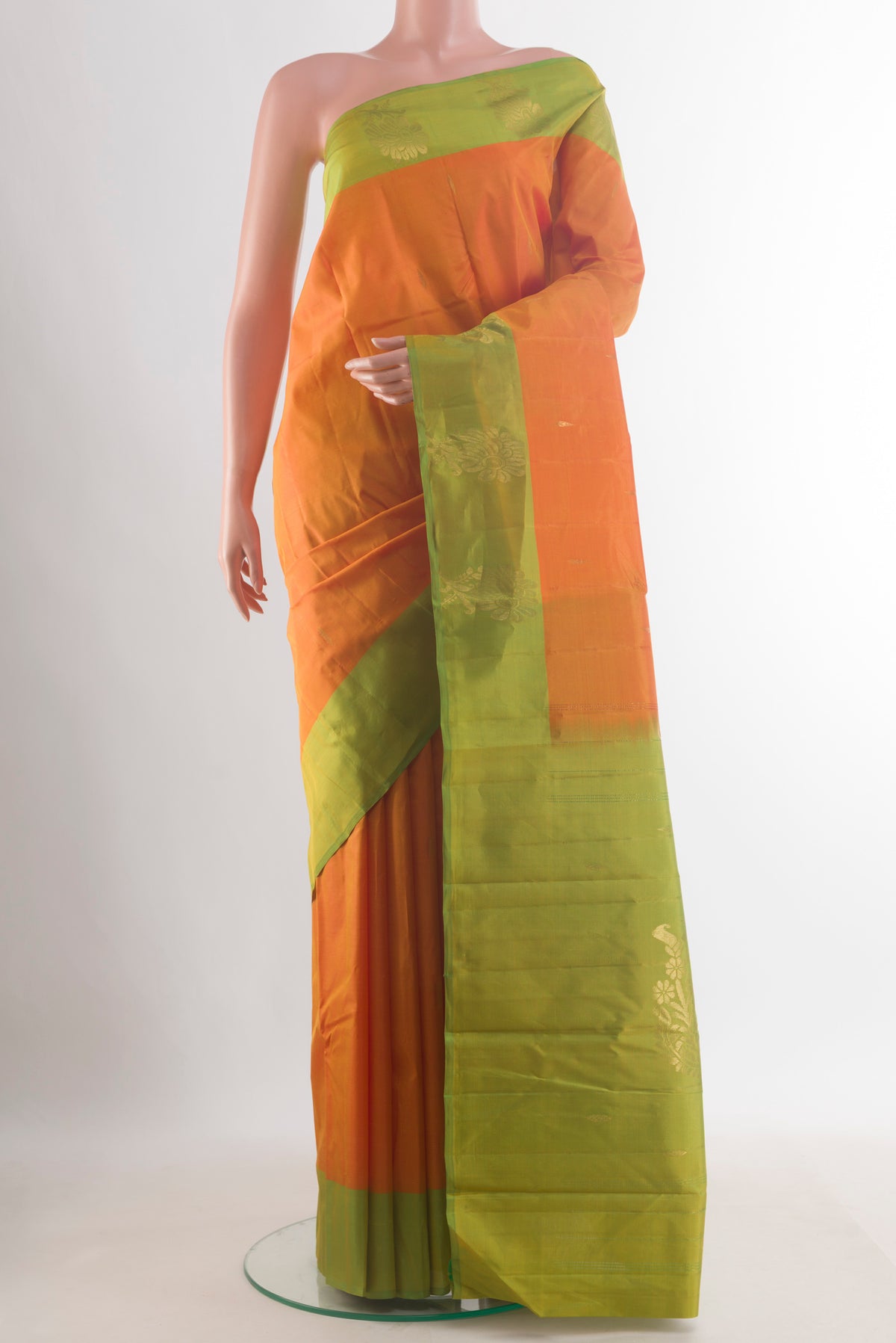 Pure Silk Orange Kanchipuram Saree with Zari Butta on the body and Zari Border.  displayed on a mannequin