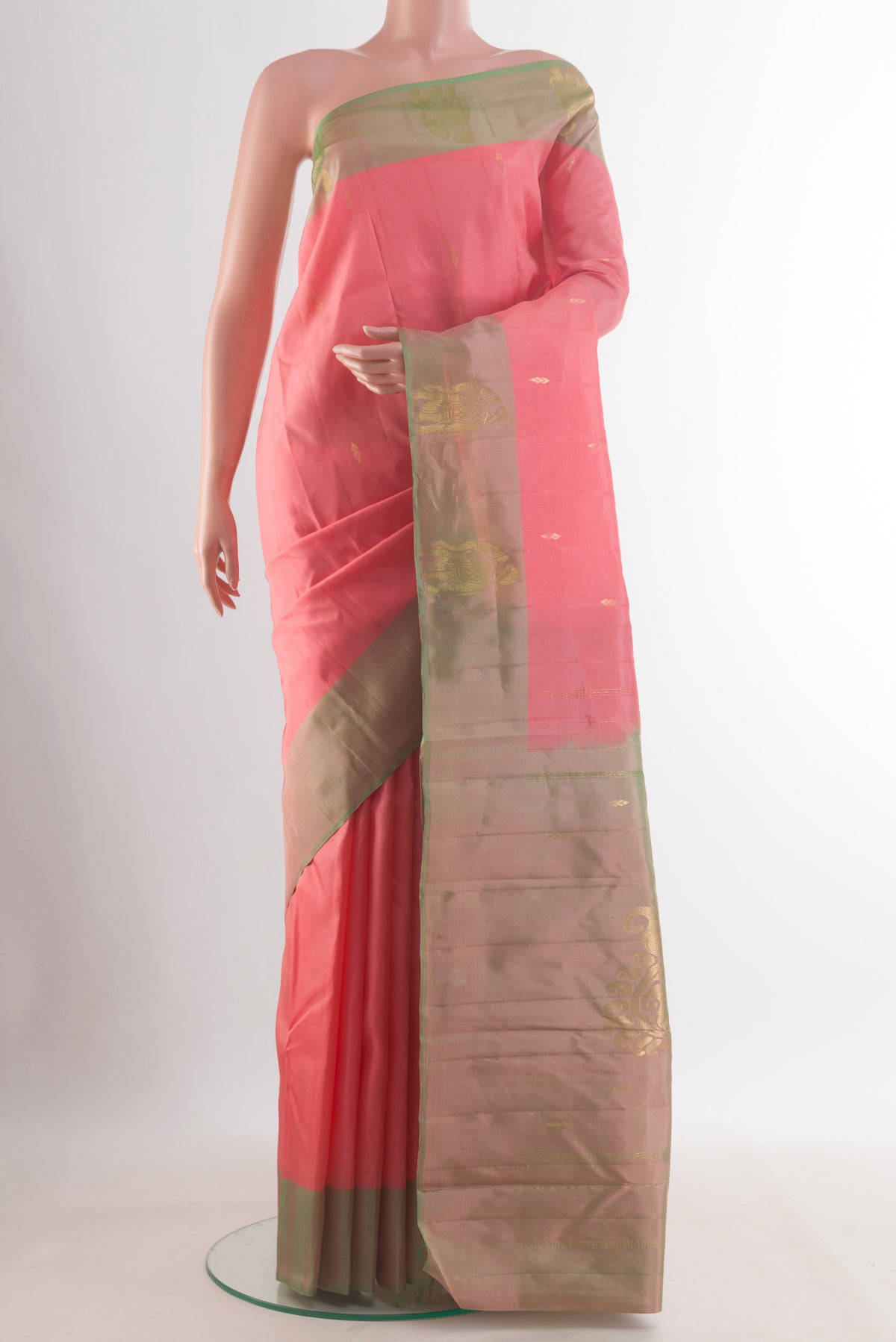 Pure Silk Coral Kanchipuram Saree with Zari Butta on the body and Zari Border.  displayed on a mannequin