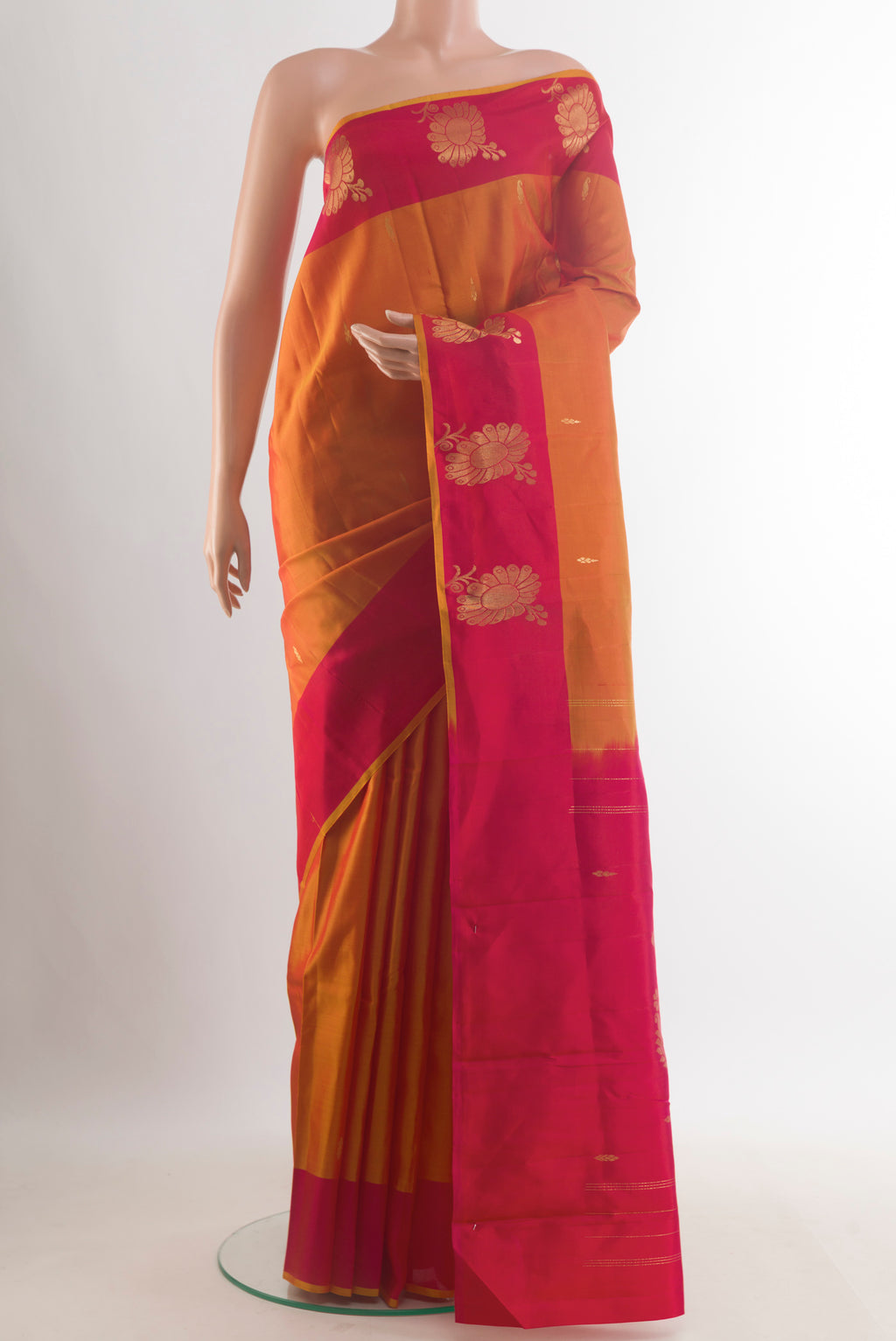 Pure Silk Mustard Kanchipuram Saree with Zari Butta on the body and Zari Border.  displayed on a mannequin