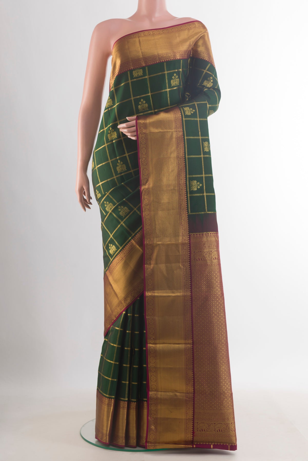 Pure Silk Bottle Green Kanchipuram Saree with Checked design on the body and Zari Border.  displayed on a mannequin
