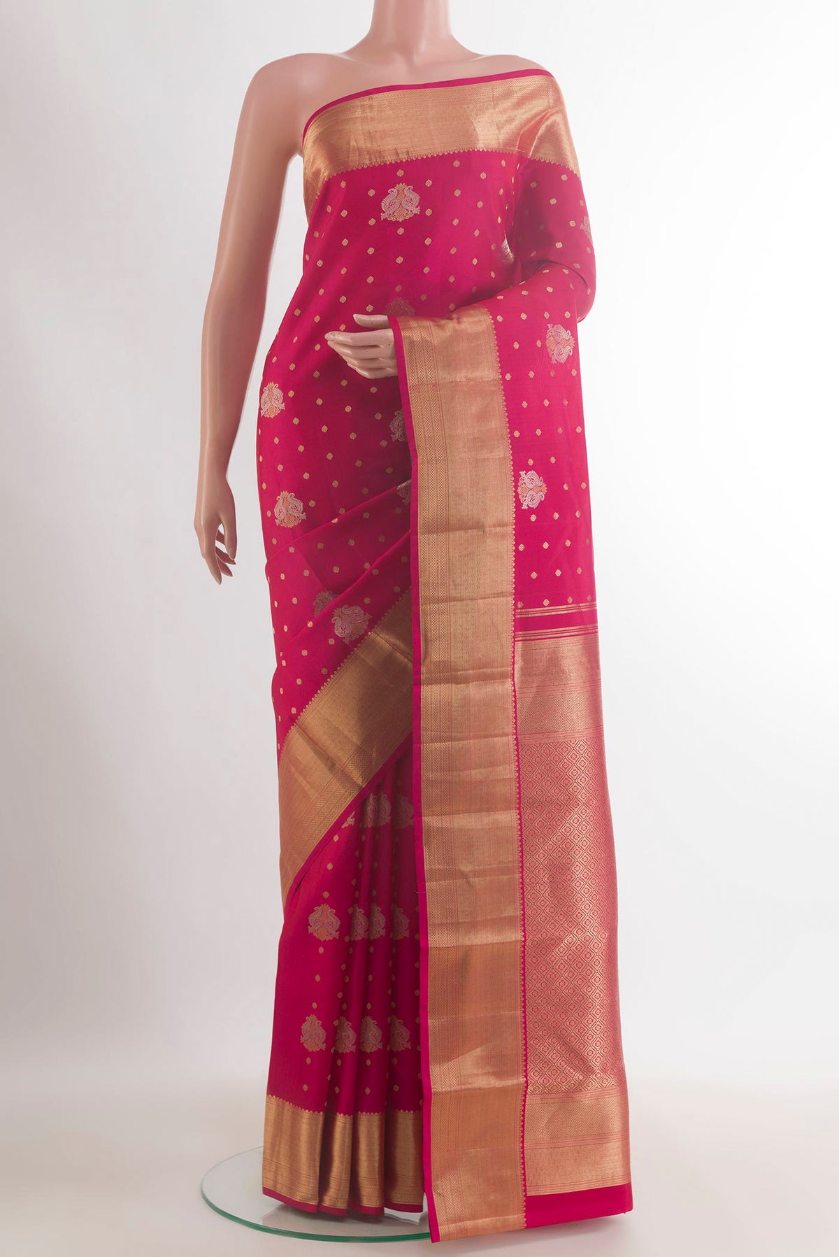 Pure Silk Pink Kanchipuram Saree with Zari Butta on the body and Zari Border.  displayed on a mannequin