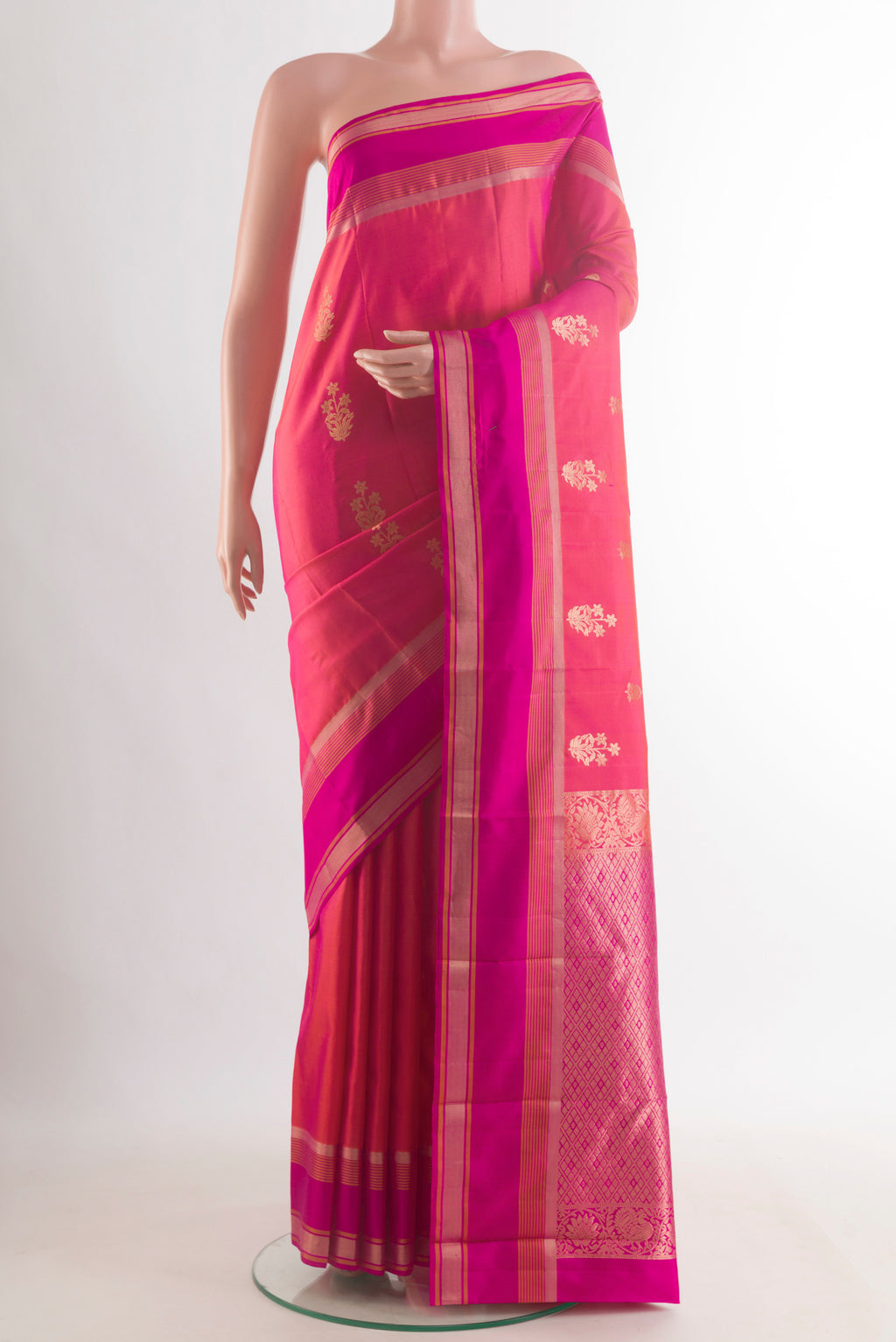 Pure Silk Coral Kanchipuram Saree with Zari Butta on the body and Zari Border.  displayed on a mannequin