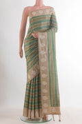 Green Tussar Saree with Stripes on the body and Embroidered Border.  displayed on a mannequin