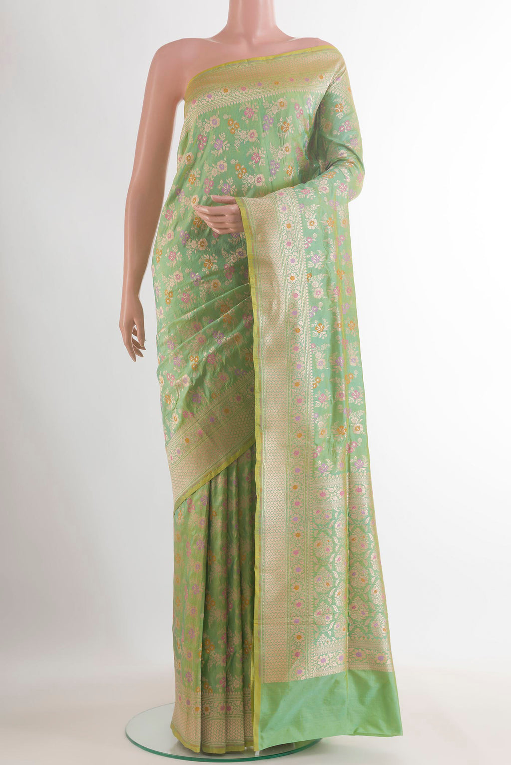 Pure Silk Green Banarasi Saree with Zari Butta on the body and Zari Border.  displayed on a mannequin