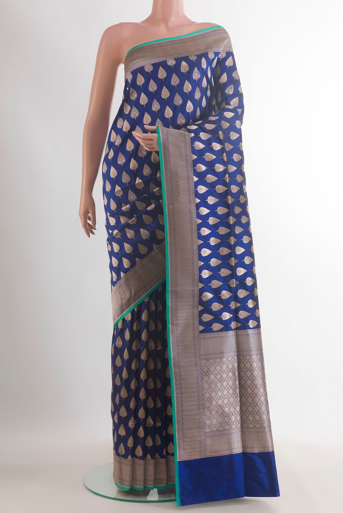 Pure Silk Blue Banarasi Saree with Zari Butta on the body and Zari Border.  displayed on a mannequin