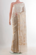 Off White Tussar Saree with Zari Butta on the body and Zari Border.  displayed on a mannequin