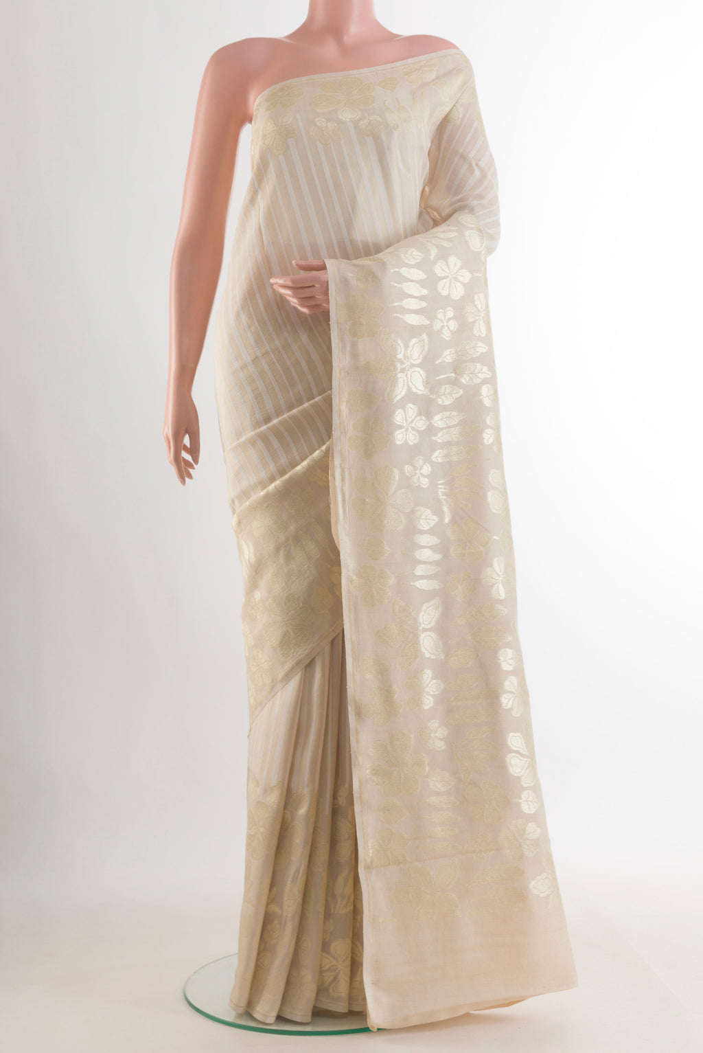 Off White Banarasi Tussar Saree with Stripes on the body and Zari Border.  displayed on a mannequin