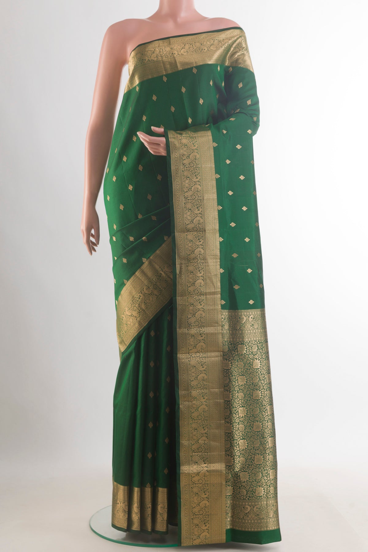 Pure Silk Green Soft Saree with Zari Butta on the body and Zari Border.  displayed on a mannequin