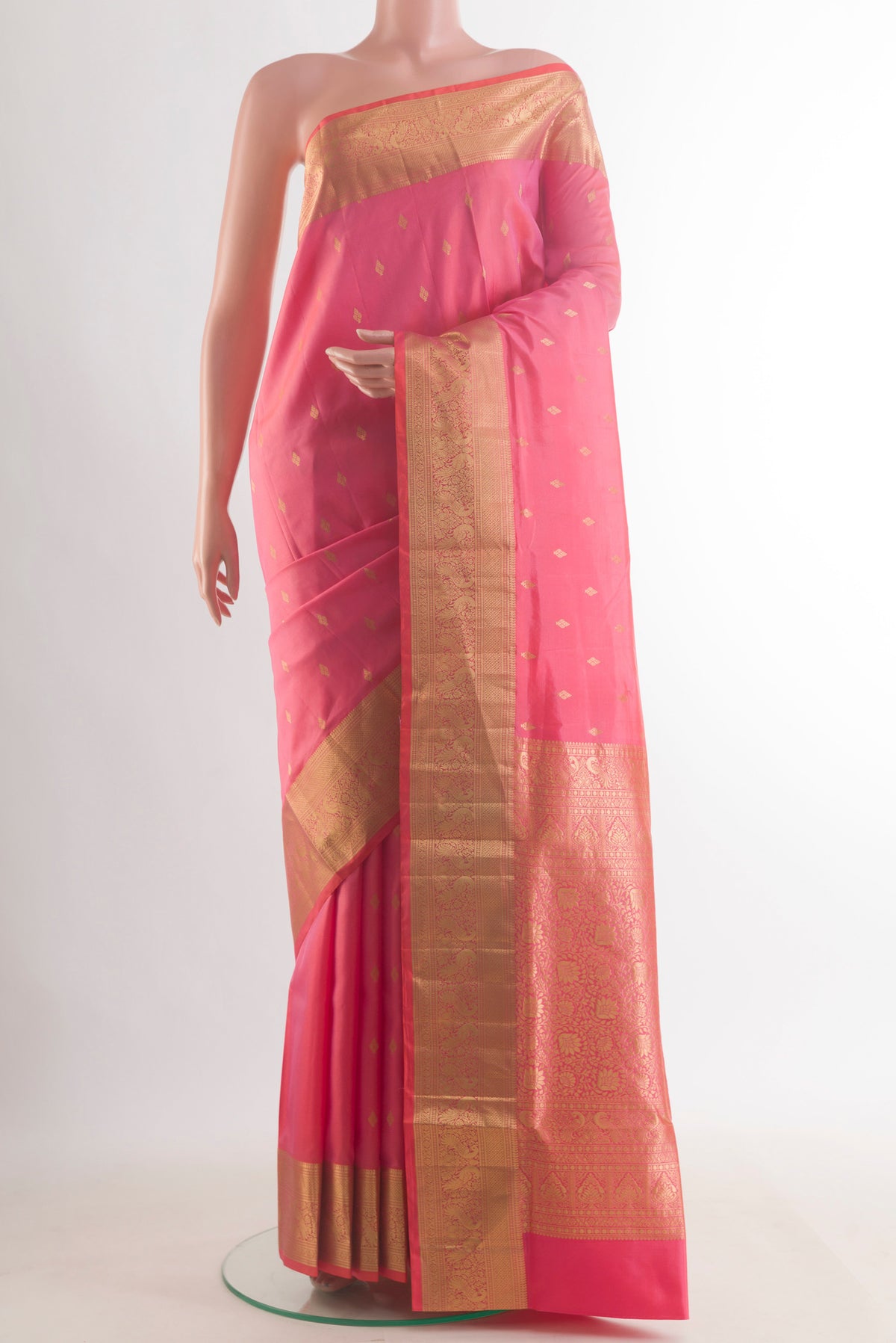 Pure Silk Pink Soft Saree with Zari Butta on the body and Zari Border.  displayed on a mannequin