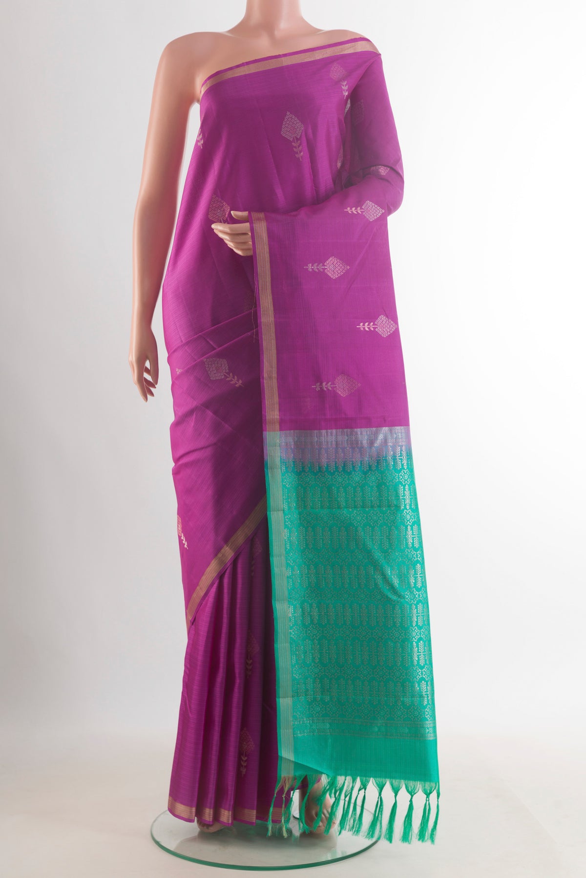 Pure Silk Magenta Kanjivaram Saree with Zari Butta on the body and Zari Border.  displayed on a mannequin