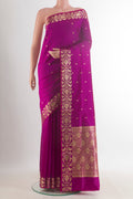 Pure Silk Magenta Banarasi Katan Saree with Zari Butta on the body and Zari Border.  displayed on a mannequin