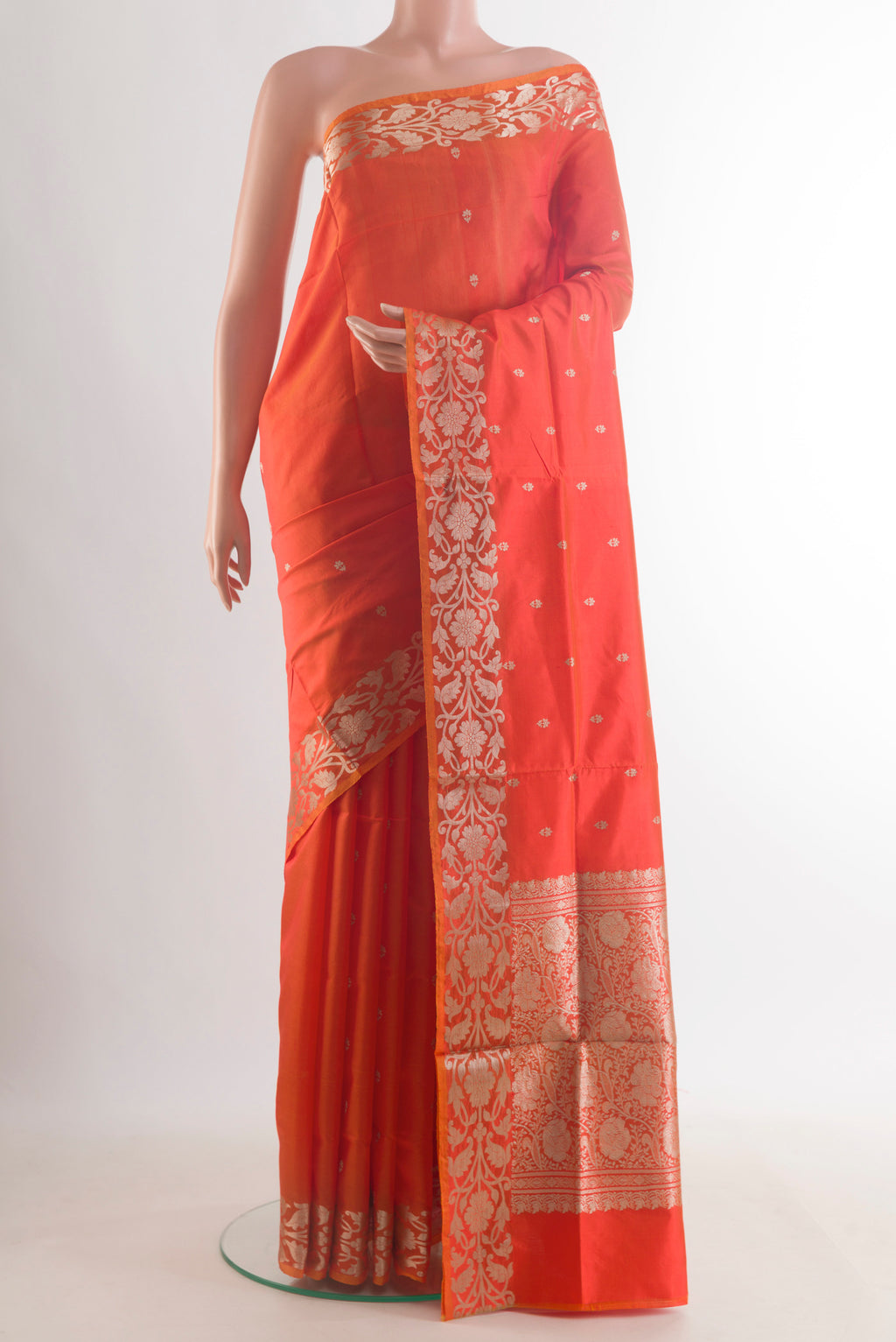 Pure Silk Orange Banarasi Katan Saree with Zari Butta on the body and Zari Border.  displayed on a mannequin