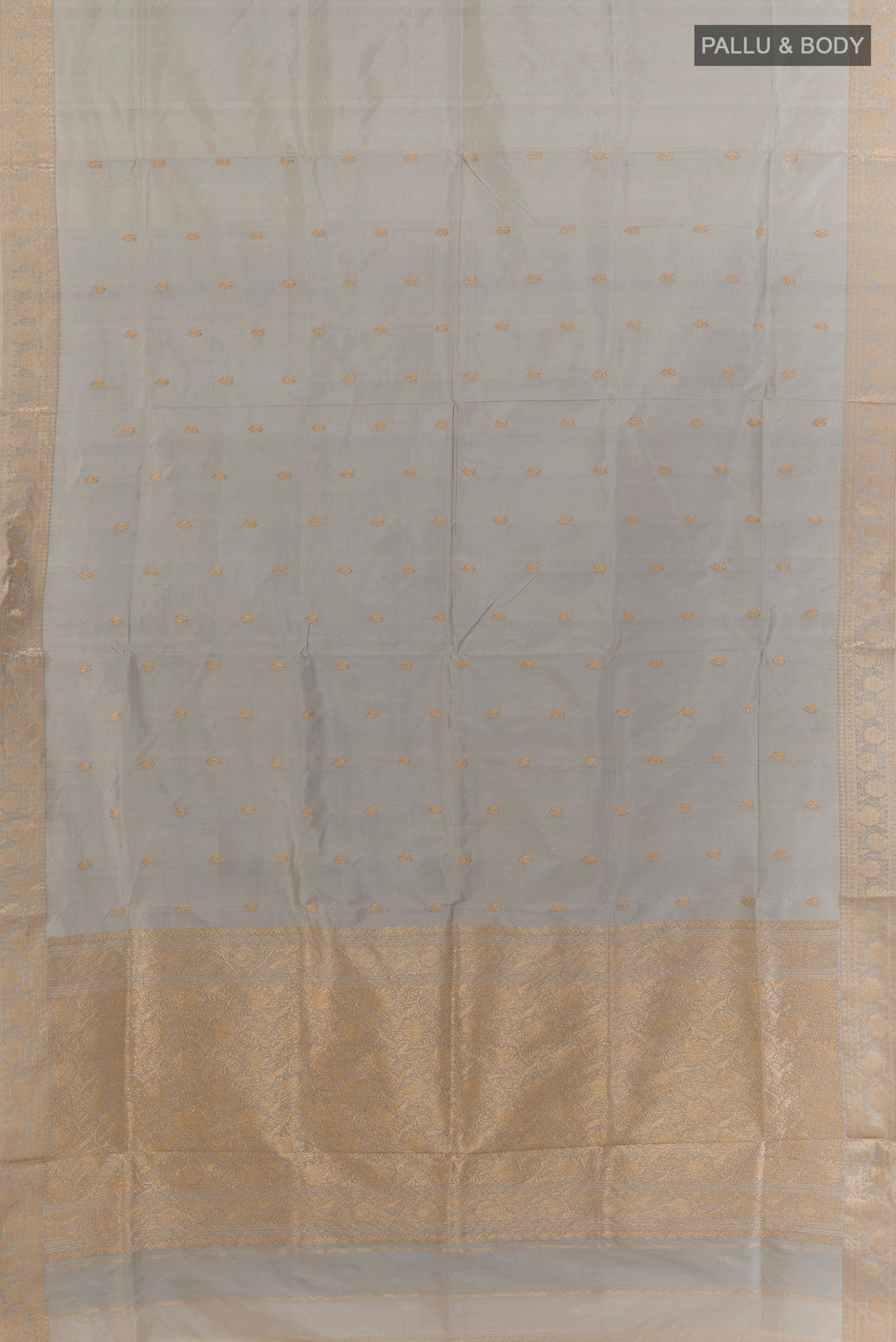 Flat view of Pure Silk Grey Banarasi Katan Saree with Zari Butta on the body and Zari Border. 