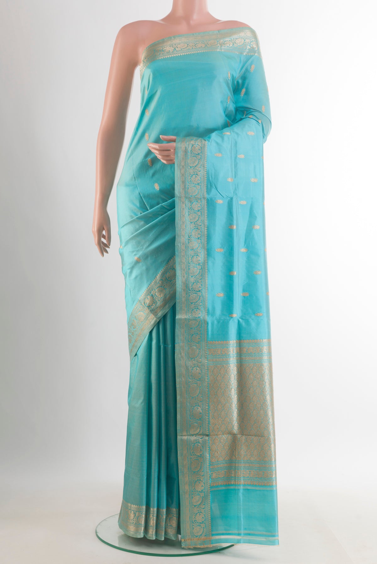 Pure Silk Light Blue Banarasi Katan Saree with Zari Butta on the body and Zari Border.  displayed on a mannequin