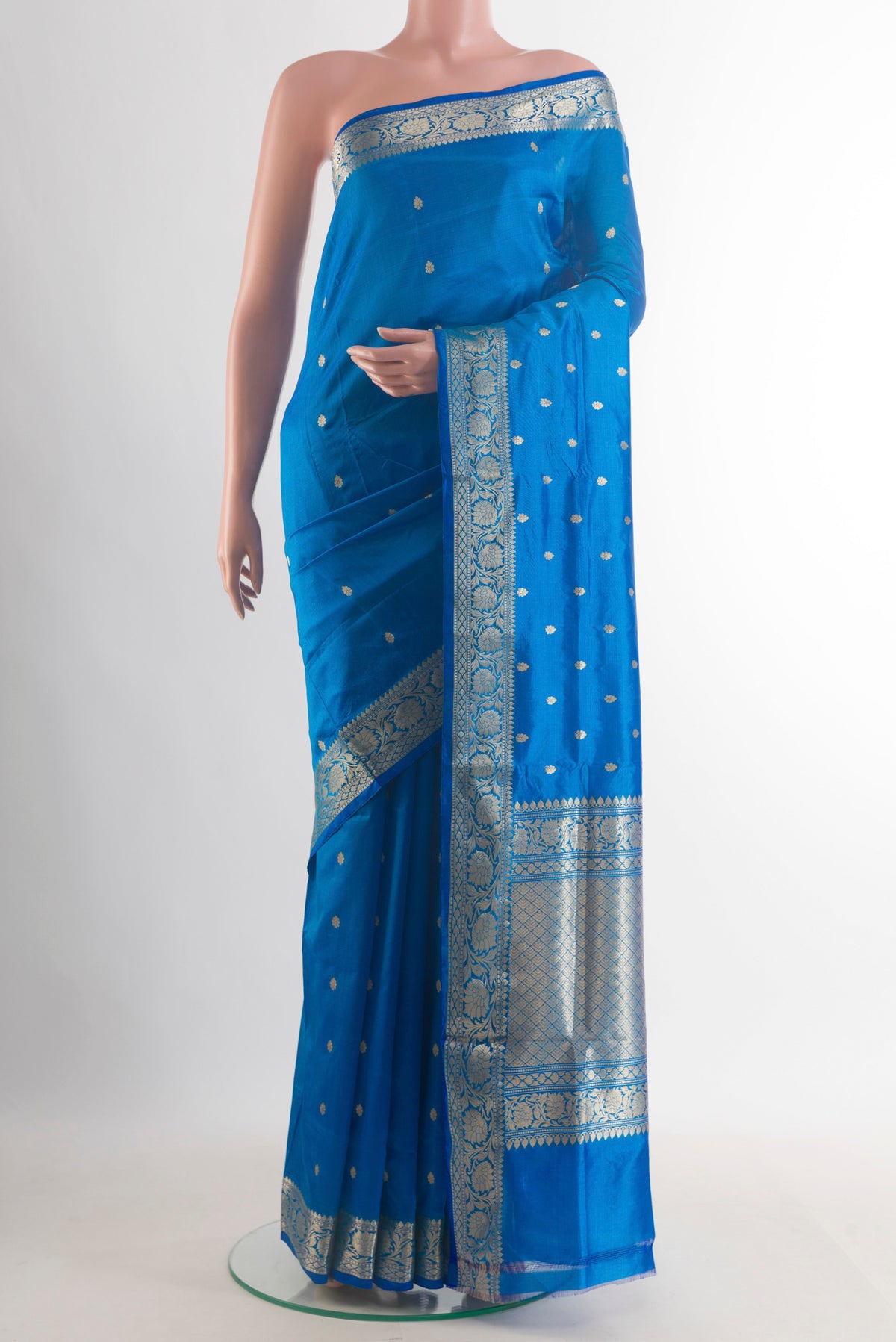 Pure Silk Electric Blue Banarasi Katan Saree with Zari Butta on the body and Zari Border.  displayed on a mannequin