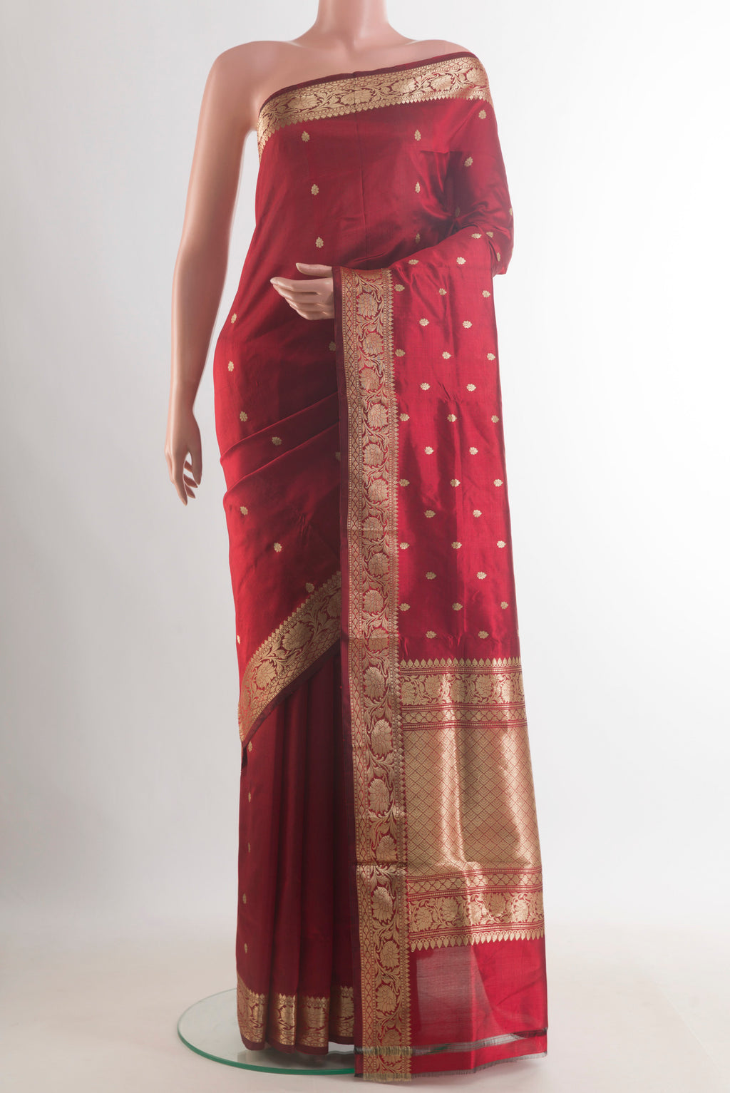 Pure Silk Maroon Banarasi Katan Saree with Zari Butta on the body and Zari Border.  displayed on a mannequin