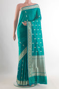 Pure Silk Sea Green Banarasi Katan Saree with Thread Butta on the body and Thread Border.  displayed on a mannequin