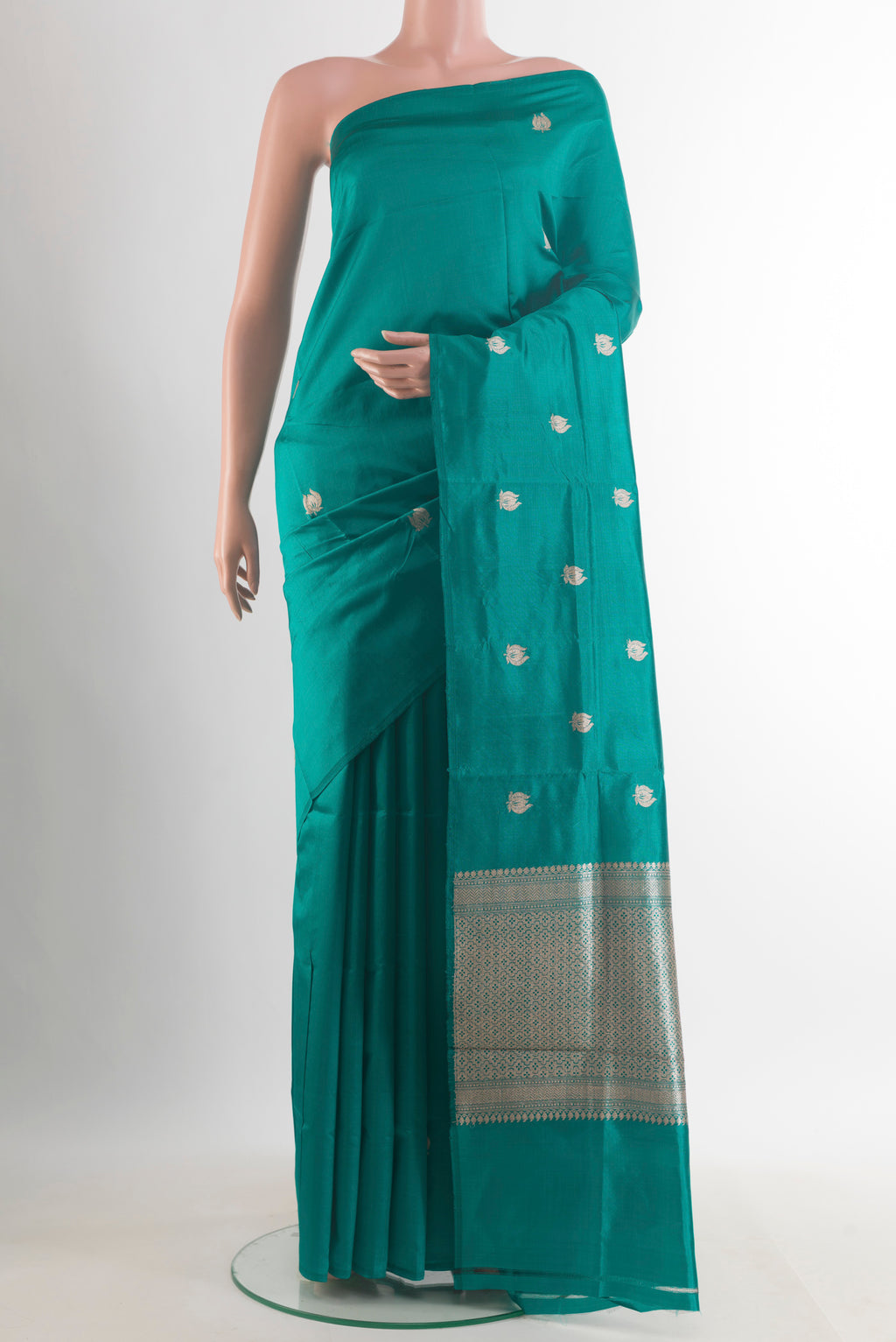 Pure Silk Teal Banarasi Katan Saree with Zari Butta on the body and Without Border.  displayed on a mannequin