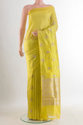 Pure Silk Yellow Banarasi Katan Saree with Zari Butta on the body and Without Border.  displayed on a mannequin