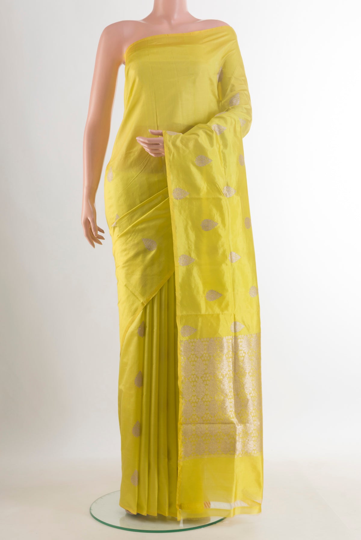 Pure Silk Yellow Banarasi Katan Saree with Zari Butta on the body and Without Border.  displayed on a mannequin