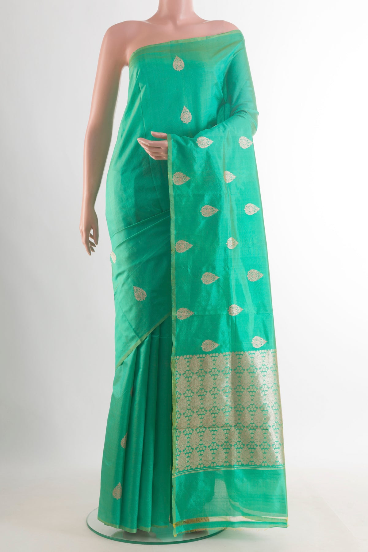 Pure Silk Green Banarasi Katan Saree with Zari Butta on the body and Without Border.  displayed on a mannequin