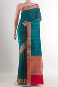 Pure Silk Teal Banarasi Katan Saree with Zari Butta on the body and Zari Border.  displayed on a mannequin