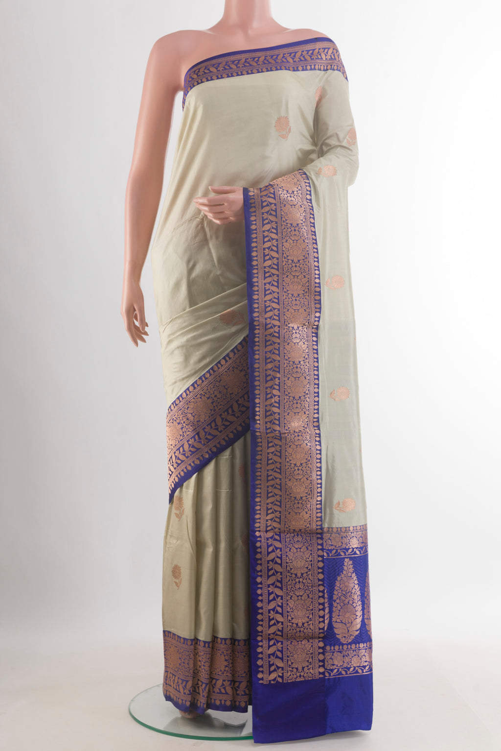 Pure Silk Off White Banarasi Katan Saree with Zari Butta on the body and Zari Border.  displayed on a mannequin