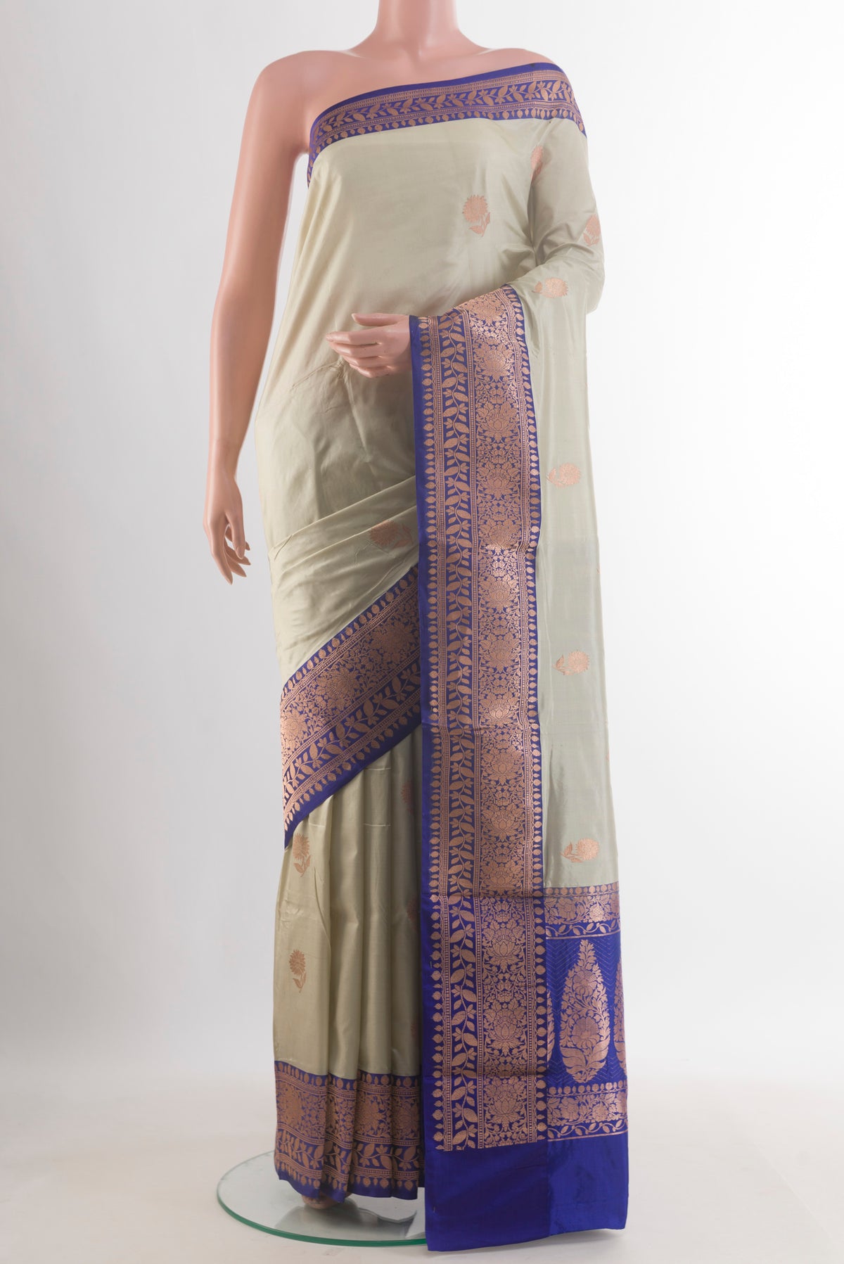 Pure Silk Off White Banarasi Katan Saree with Zari Butta on the body and Zari Border.  displayed on a mannequin