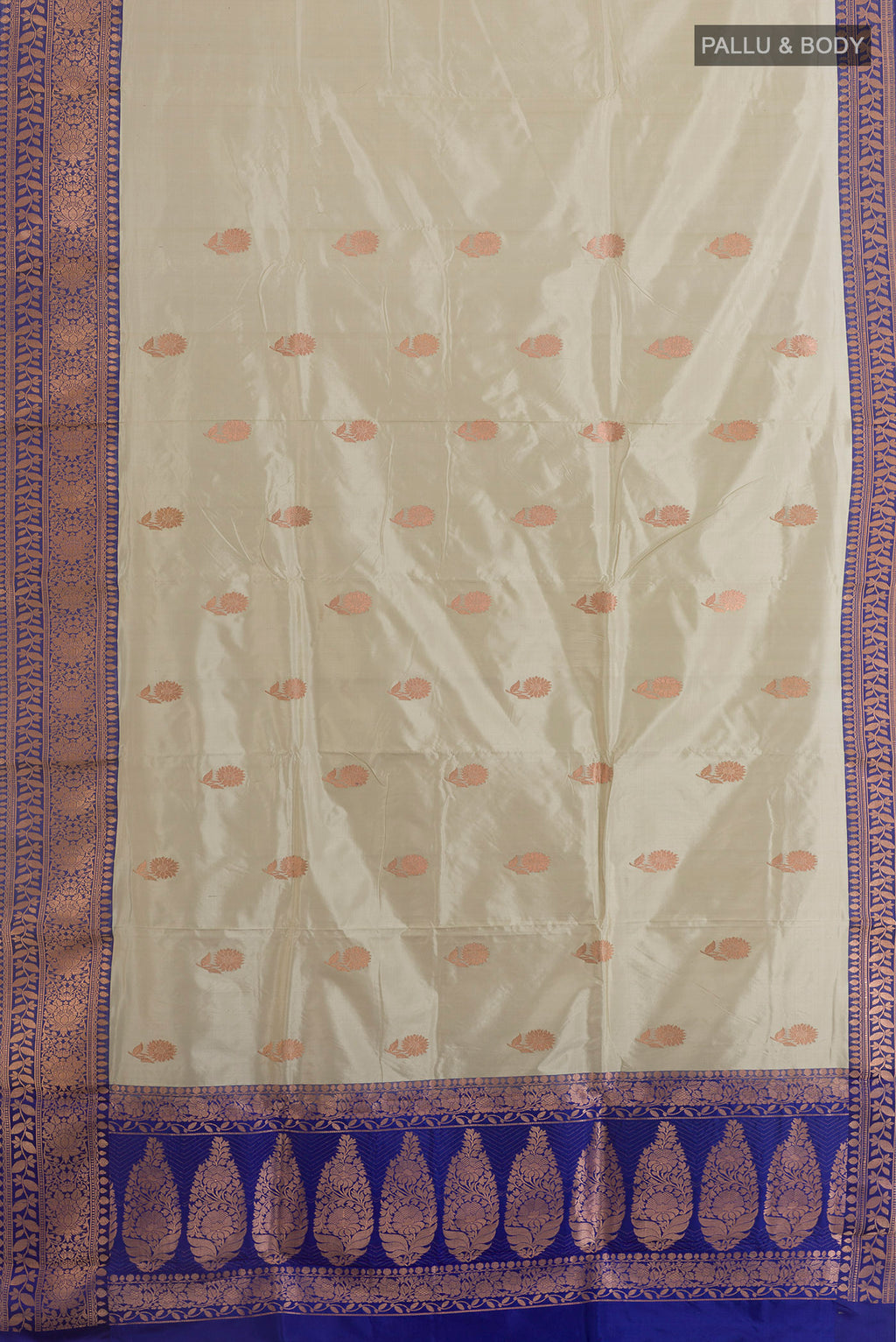 Flat view of Pure Silk Off White Banarasi Katan Saree with Zari Butta on the body and Zari Border. 