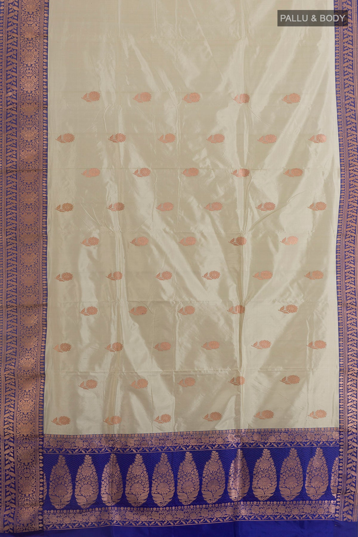 Flat view of Pure Silk Off White Banarasi Katan Saree with Zari Butta on the body and Zari Border. 