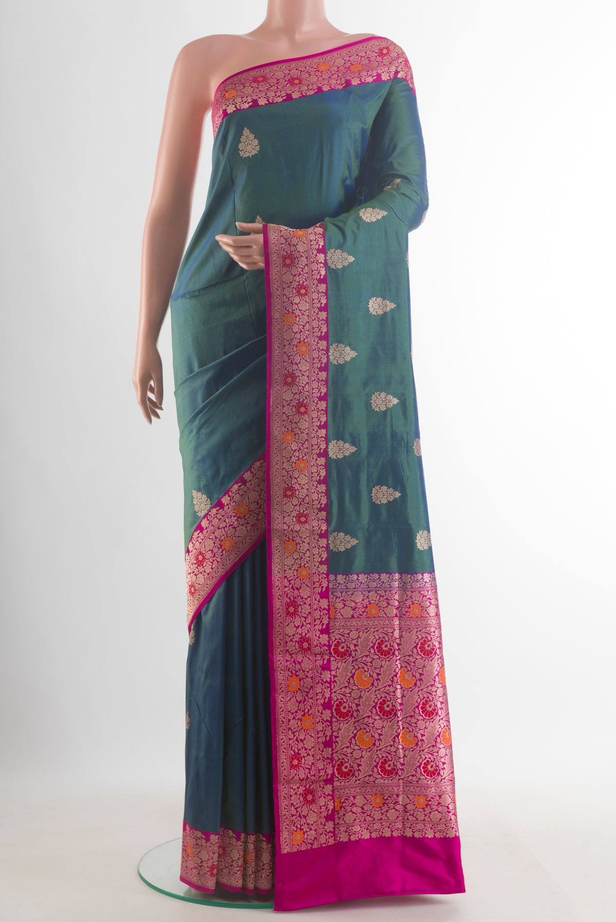 Pure Silk Blue with Green Color Banarasi Katan Saree with Zari Butta on the body and Zari Border.  displayed on a mannequin