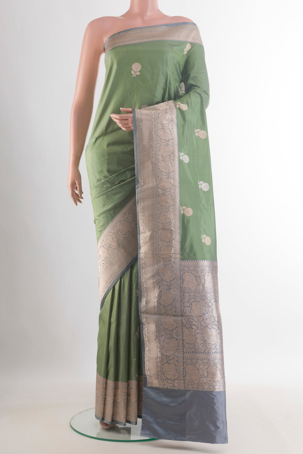 Pure Silk Sage Green Banarasi Katan Saree with Zari Butta on the body and Zari Border.  displayed on a mannequin