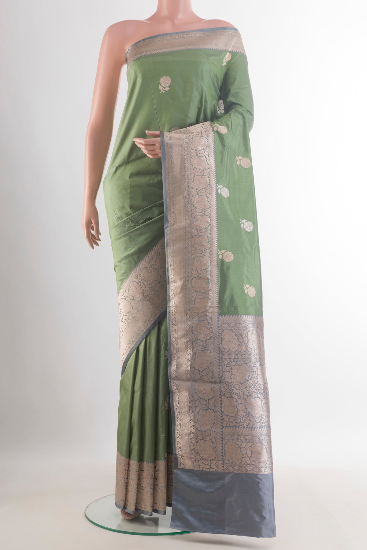 Pure Silk Sage Green Banarasi Katan Saree with Zari Butta on the body and Zari Border.  displayed on a mannequin