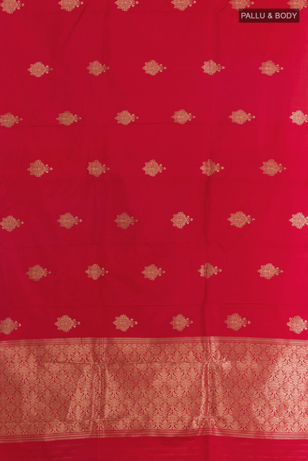 Flat view of Red Banarasi Saree with Zari Butta on the body and Zari Border. 