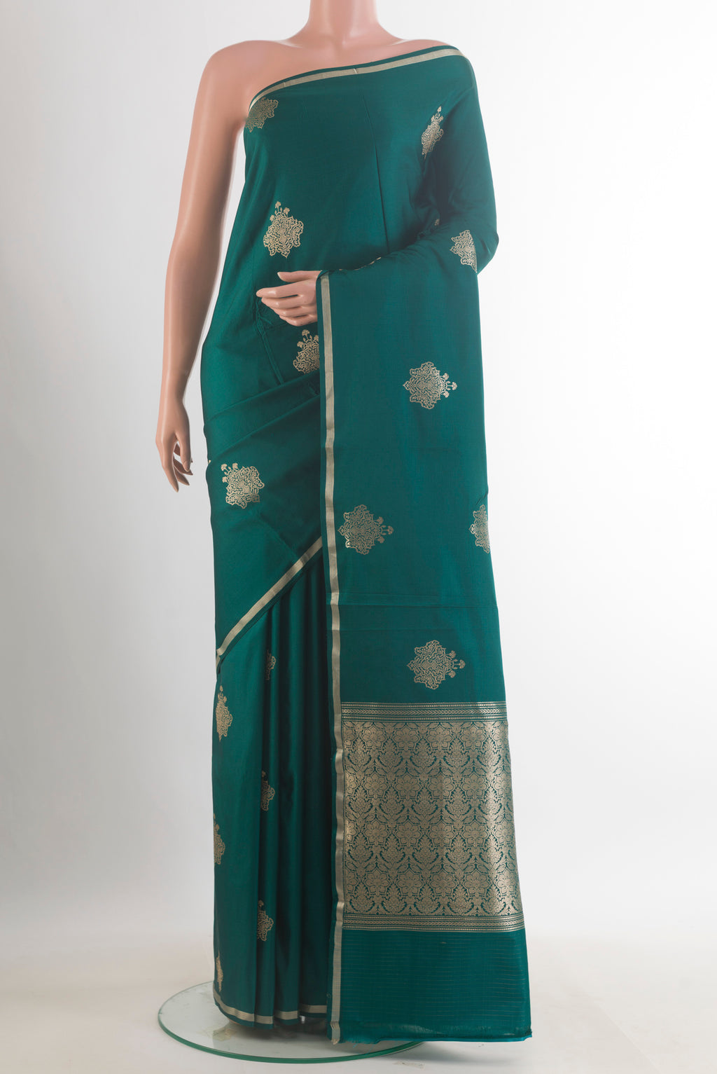 Green Banarasi Saree with Zari Butta on the body and Zari Border.  displayed on a mannequin