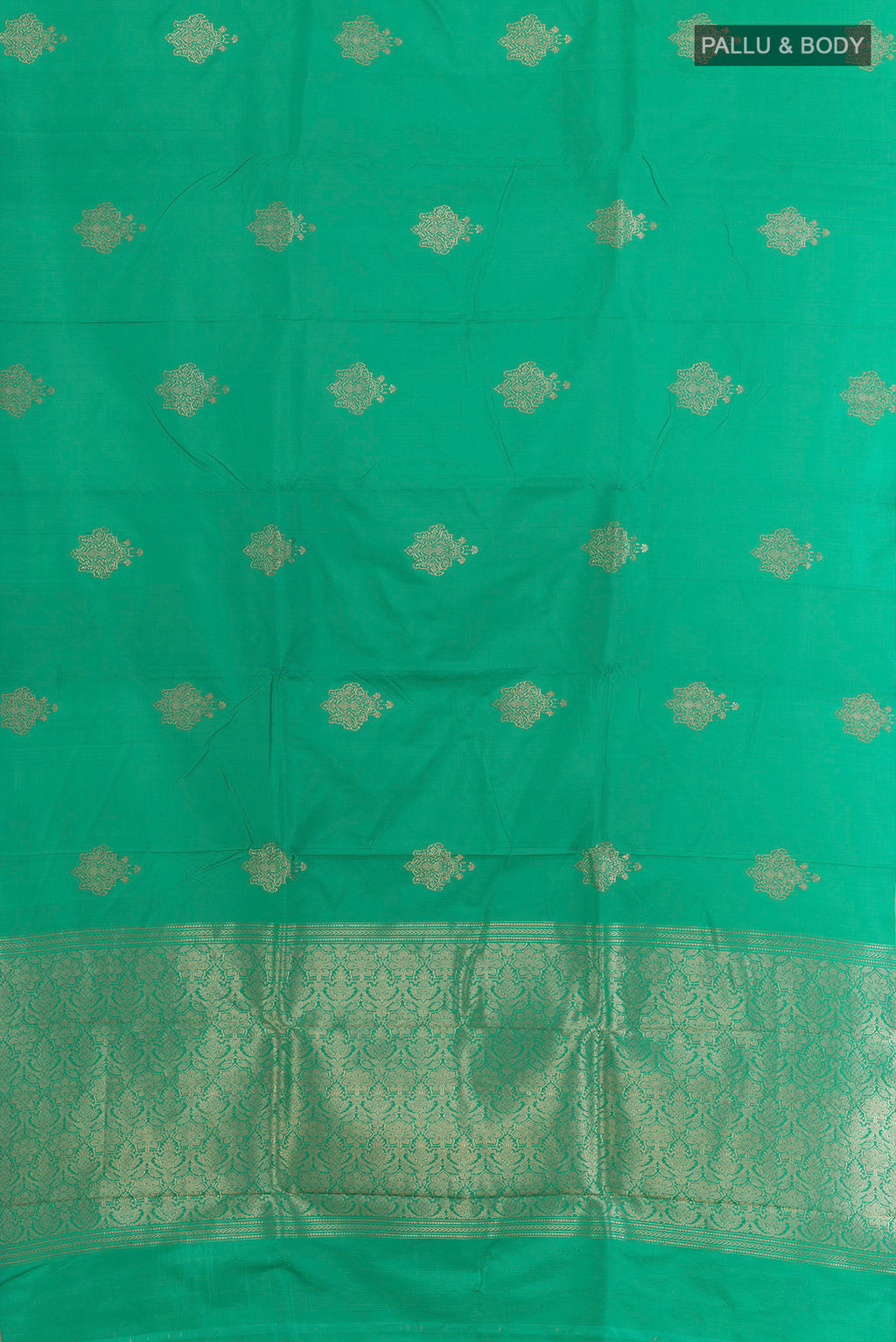 Flat view of Green Banarasi Saree with Zari Butta on the body and Zari Border. 