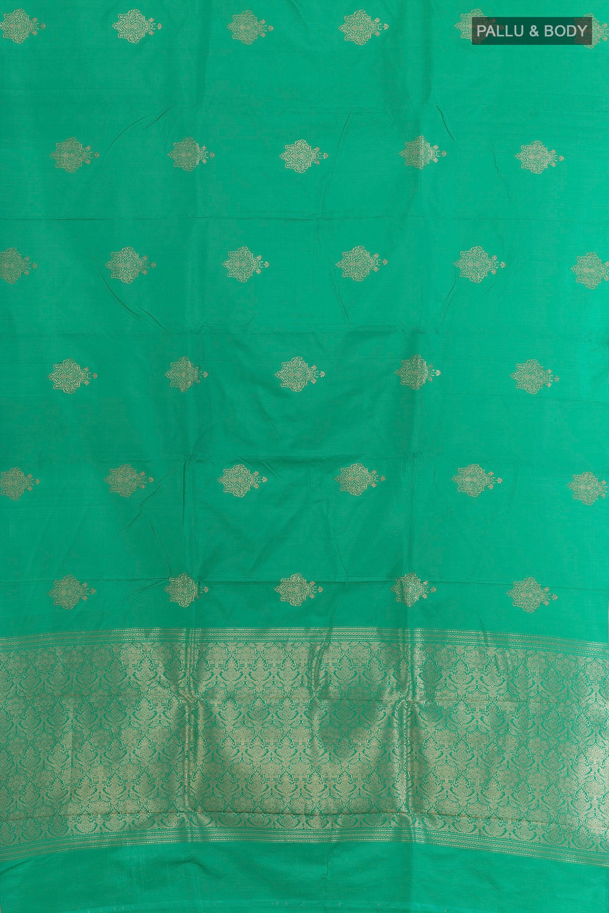 Flat view of Green Banarasi Saree with Zari Butta on the body and Zari Border. 