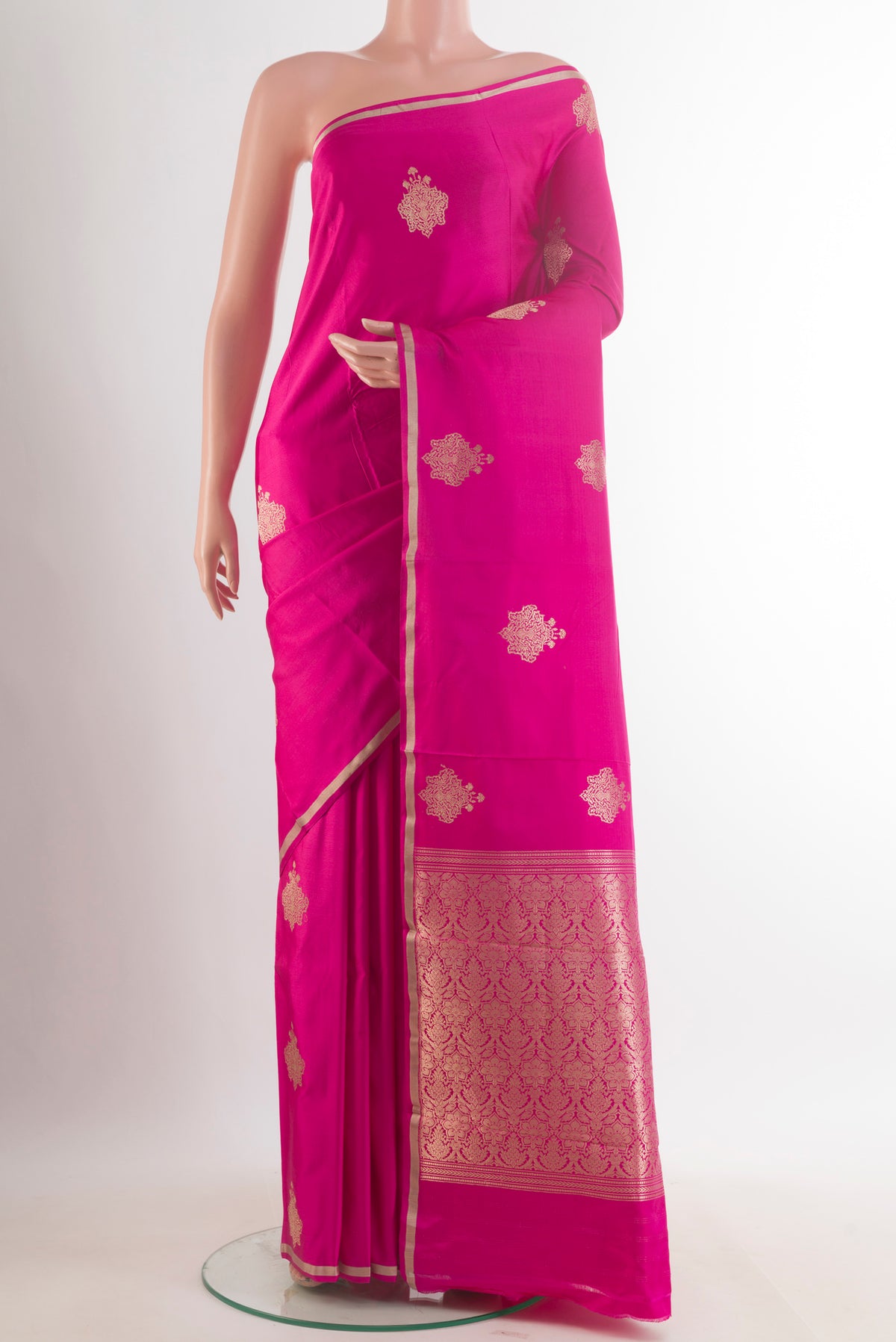 Pink Banarasi Saree with Zari Butta on the body and Zari Border.  displayed on a mannequin