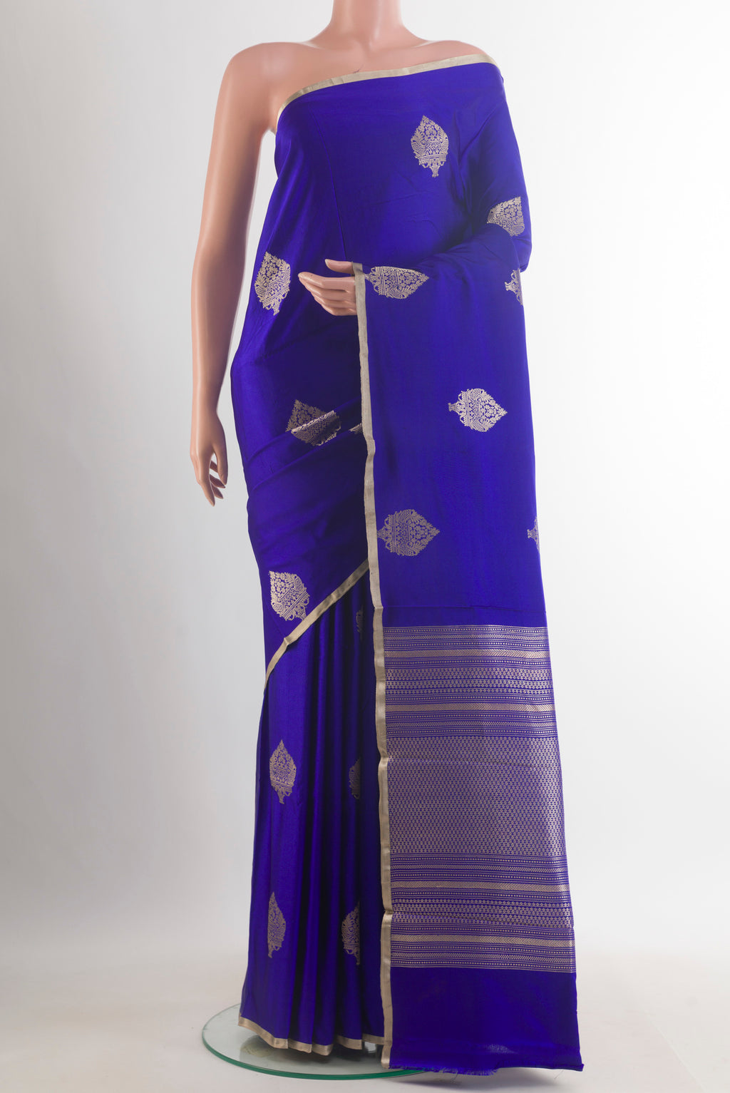 Royal Blue Banarasi Saree with Zari Butta on the body and Zari Border.  displayed on a mannequin