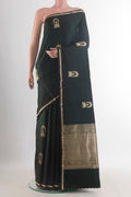 Bottle Green Banarasi Saree with Zari Butta on the body and Zari Border.  displayed on a mannequin