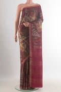 Brown Tussar Saree with Printed design on the body and Zari Border.  displayed on a mannequin