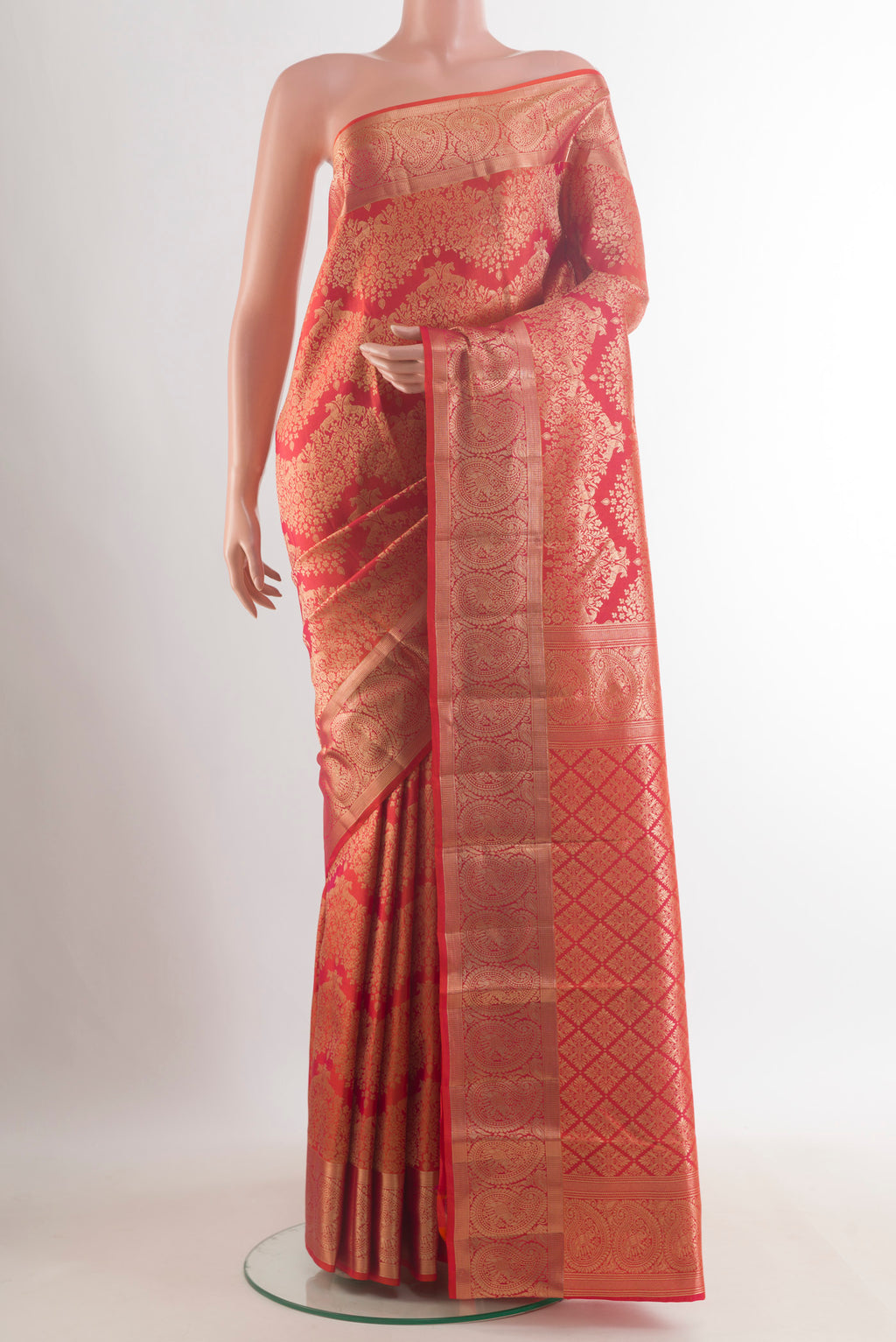 Pure Silk Orange Kanchipuram Saree with Zari Brocade on the body and Zari Border.  displayed on a mannequin