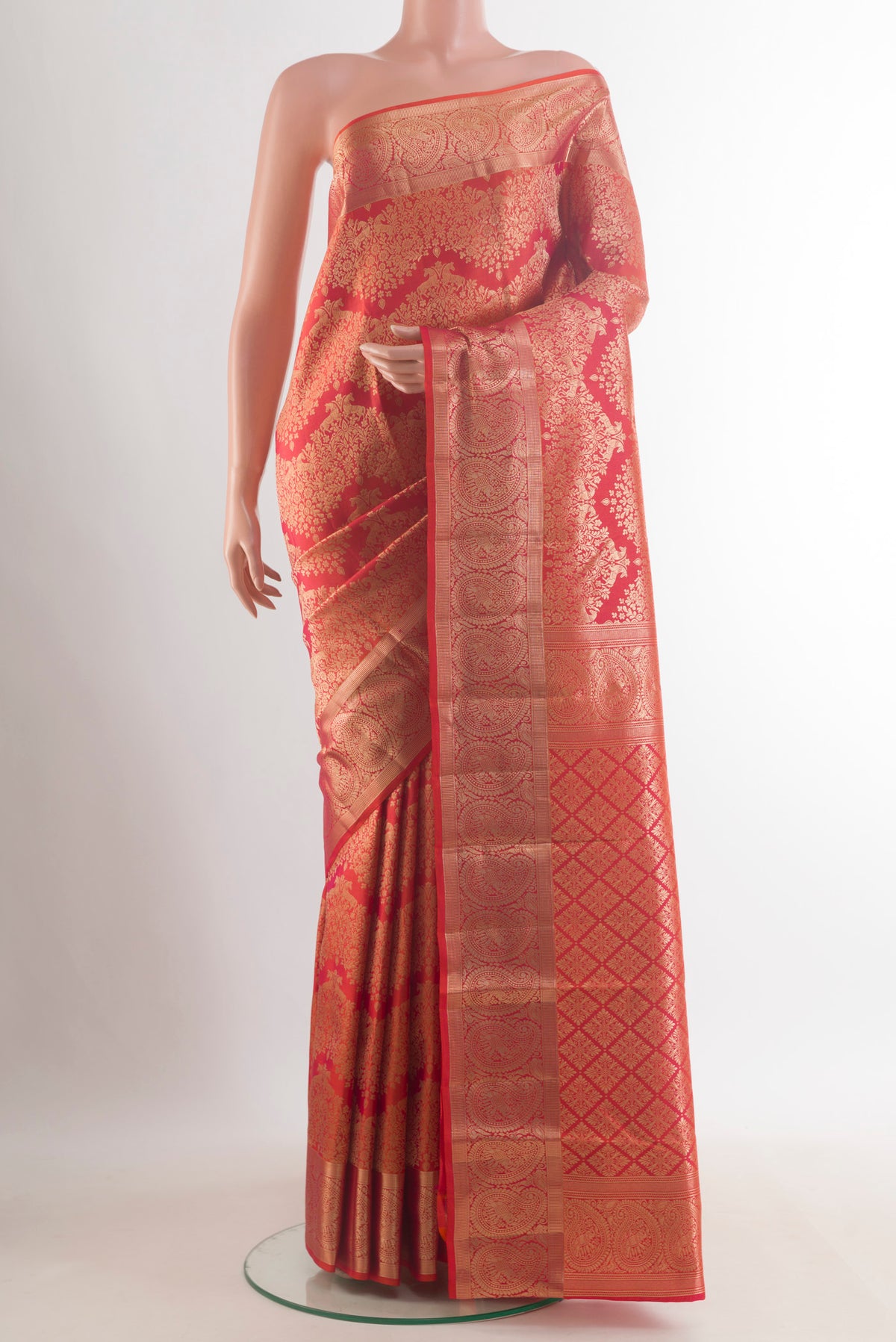 Pure Silk Orange Kanchipuram Saree with Zari Brocade on the body and Zari Border.  displayed on a mannequin