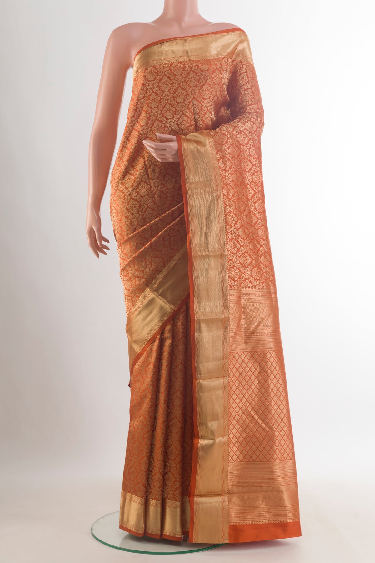 Pure Silk Rust Kanchipuram Saree with Zari Brocade on the body and Zari Border.  displayed on a mannequin