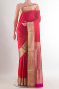 Pure Silk Orange Soft Saree with Plain Body and Zari Border.  displayed on a mannequin