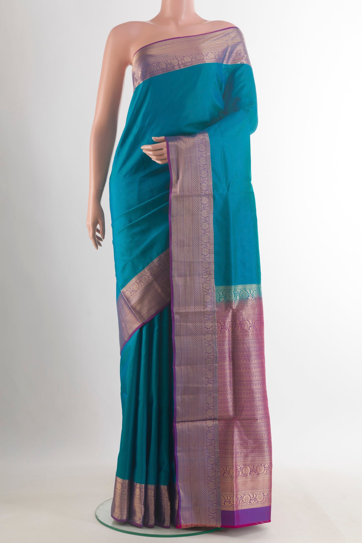 Pure Silk Blue Soft Saree with Plain Body and Zari Border.  displayed on a mannequin